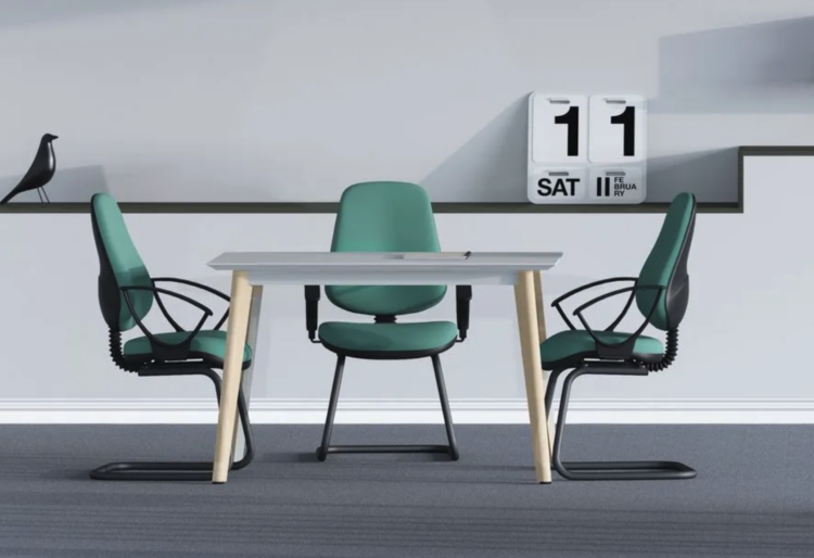 Green office chairs around a white wooden table in an office.
